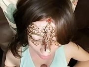 Masked brunette gives clothed titty fucking