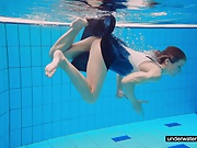 Teen girl Avenna is swimming in the pool