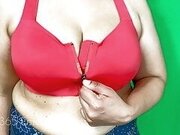 Busty Girl strips sports bra and shows her huge boobs cleavage