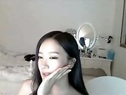 Asian babe wearing a cop uniform strips in webcam solo scene
